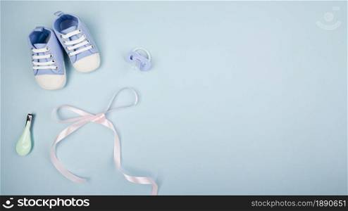 ribbon with baby shoes copy space . Resolution and high quality beautiful photo. ribbon with baby shoes copy space . High quality and resolution beautiful photo concept