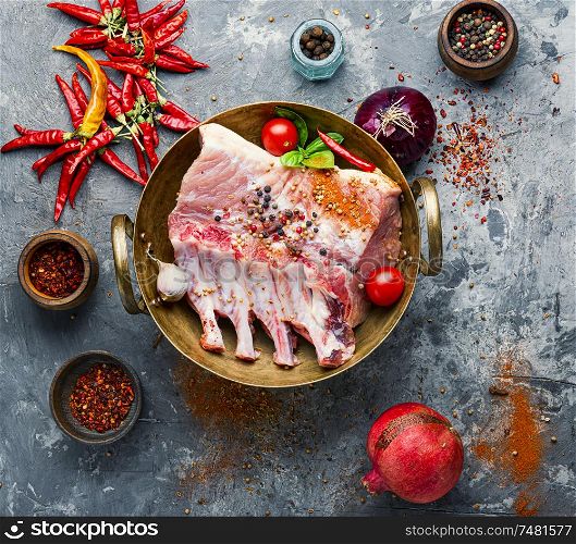Ribs and pork chops uncooked.Fresh,raw meat and spices. Raw rack of pork