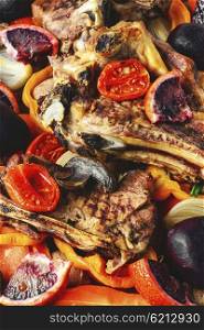 Ribs with grilled meat. Beef on the bone baked in vegetables and orange