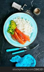 rice brocoli salnob on plate on a table