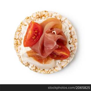 Rice cakes with cream cheese, prosciutto and tomato top view isolated on white background. Rice cakes with cream cheese, prosciutto and tomato