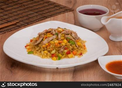 rice dish with sauce on a dark background. rice dish in a bowl