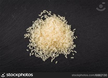 Rice heap close up on a dark background