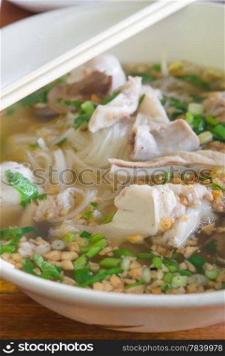 rice noodle soup with meat and vegetable with chopsticks. noodle soup