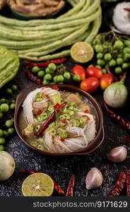 Rice noodles and coconut milk mixed with chilies, bitter melon, lentils, lemons, garlic and eggplant.