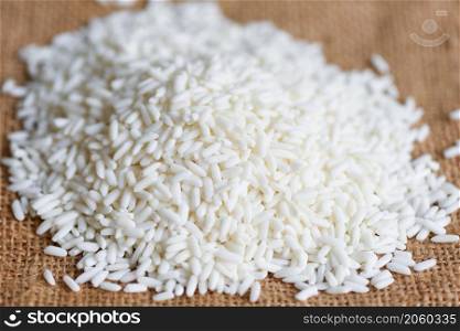 Rice on sack and harvested rice, harvest rice and food grains cooking concept