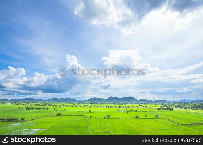 Rice paddy fields and mountains behind the clouds covered the sky.&#xA;