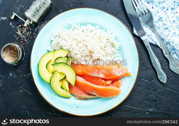 rice salmon avocado on plate on a table