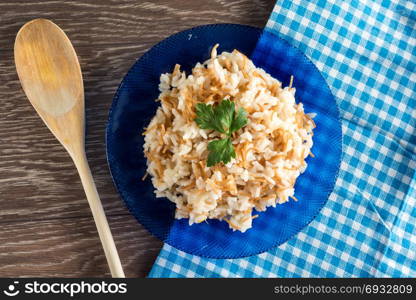 Rice served on blue plate on the table