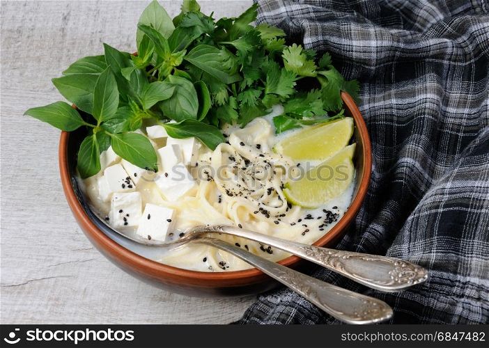 Rice soup with noodles and tofu flavored with lemon grass (basil), cilantro, sesame.