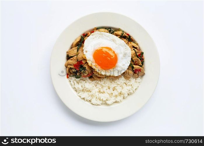 Rice topped with stir-fried chicken and holy basil, fried egg, white background.