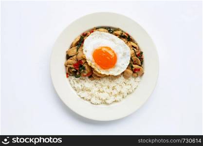 Rice topped with stir-fried chicken and holy basil, fried egg, white background.
