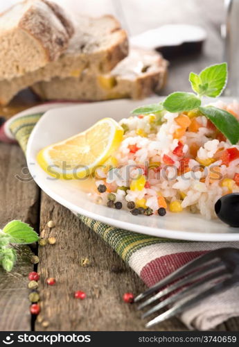 Rice, vegetables and bread on a wooden table