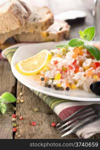 Rice, vegetables and bread on a wooden table