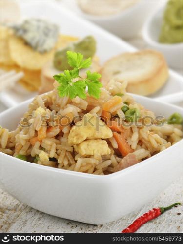 Rice With Chicken And Vegetables In A White Bowl