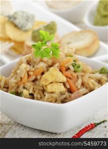 Rice With Chicken And Vegetables In A White Bowl