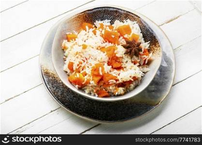 Rice with fragrant and juicy pumpkin. Vegetable pilaf. Rice porridge with pumpkin