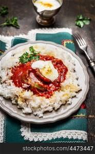 rice with meat,vegetables and tomato and yoghurt sauce , close up