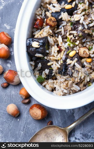rice with mushrooms. traditional risotto from rice and mushrooms and hazelnut