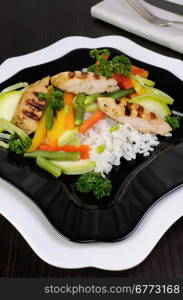 Rice with slices of chicken breast and vegetables