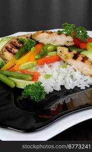 Rice with slices of chicken breast and vegetables