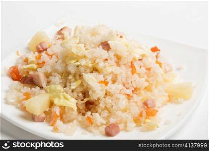 Rice with vegetable on a plate isolated over white
