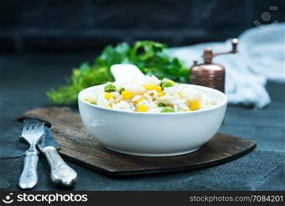rice with vegetables in bowl and on a table