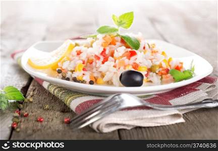 Rice with vegetables on a wooden table