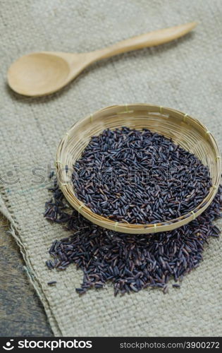 Riceberry rice. raw purple Riceberry rice in bamboo basket with wooden spoon