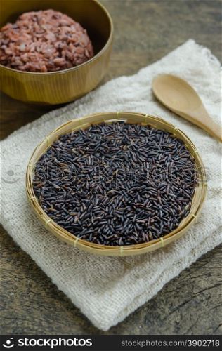 Riceberry rice. raw purple Riceberry rice in bamboo basket with wooden spoon