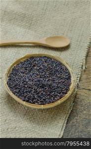 Riceberry rice. raw purple Riceberry rice in bamboo basket with wooden spoon