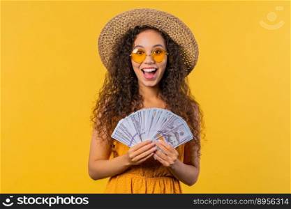 Rich excited curly haired woman with cash money - USD currency dollars banknotes on yellow wall. Symbol of jackpot, gain, victory, winning the lottery. High quality photo. Rich excited curly haired woman with cash money - USD currency dollars banknotes