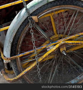 Rickshaw tied up with a chain and padlock, Colonia Landivar, Guatemala City, Guatemala