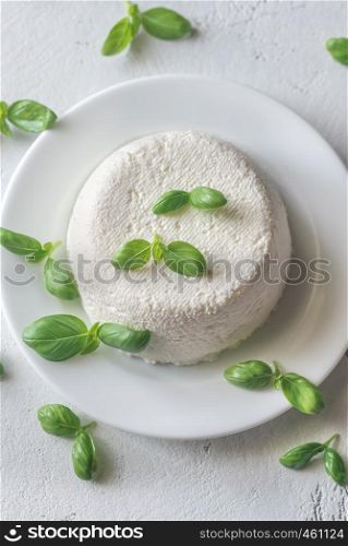 Ricotta - Italian whey cheese with fresh basil leaves