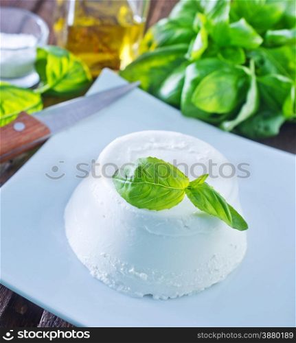 ricotta on the white plate and on a table