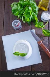 ricotta on the white plate and on a table