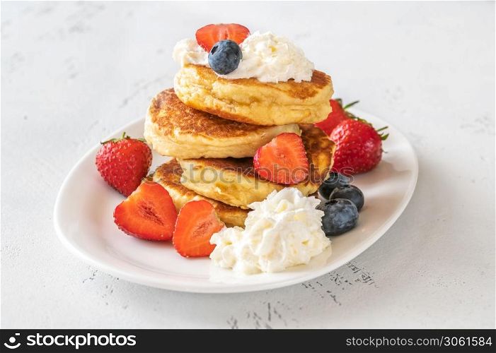 Ricotta pancakes with whipped cream and fresh berries