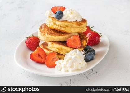 Ricotta pancakes with whipped cream and fresh berries