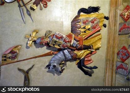 Rider medieval to sculpture on a ceiling with its coat of arms.