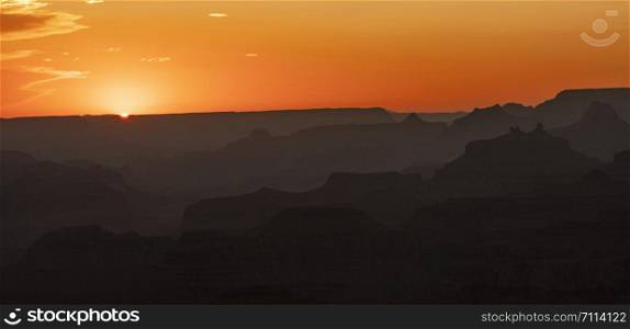 Ridges and Valleys cut by the Colorado River absorb light from an Arizona sunset