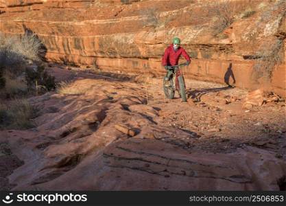riding a fat mountain bike on a slickrock at the sandstone canyon bottom - Ruby Wash in Red Mountain Open Space north of Fort Collins, Colorado