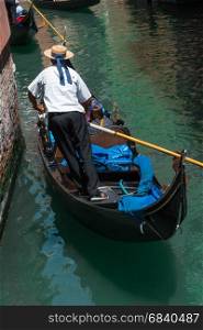 Riding Gondola Along one of the Many Venetian Canals, Italy
