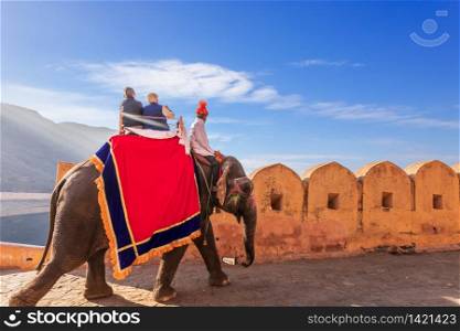 Riding on elephats, famous tourist attraction in Amber Fort of Jaipur, India.