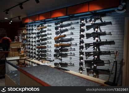 Rifle choice, showcase in gun shop, nobody. Euqipment for hunters on stand in weapon store, hunting and sport shooting hobby. Rifle choice, showcase in gun shop, nobody