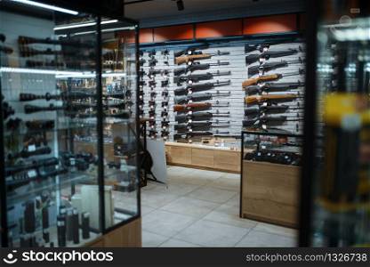 Rifle choice, showcase in gun shop, nobody. Euqipment for hunters on stand in weapon store, hunting and sport shooting hobby. Rifle choice, showcase in gun shop, nobody