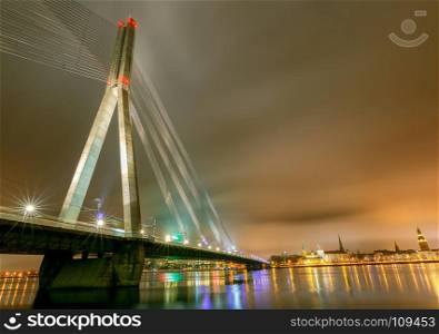 Riga. Cable-stayed bridge.. Modern cable-stayed bridge across the Daugava River in Riga night.