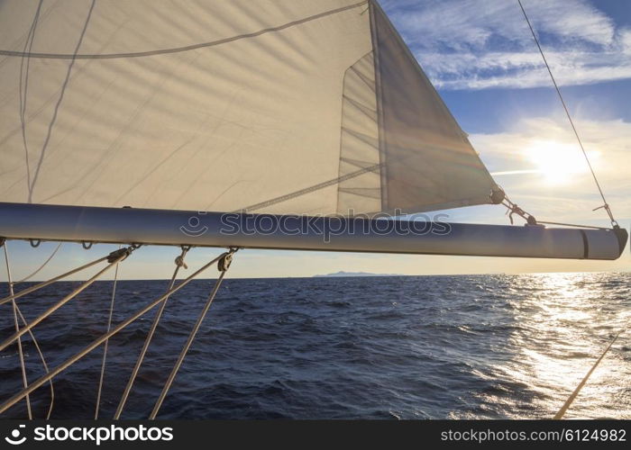 Rigging, ropes, shrouds and sail crop on the yacht at sunset