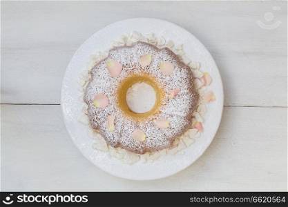 Ring cake with icing sugar and flower. Ring cake with icing sugar and flowers