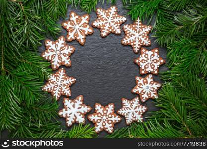 ring of gingerbread cookies on the slate table with pine branches. ring of gingerbread cookies on the slate table