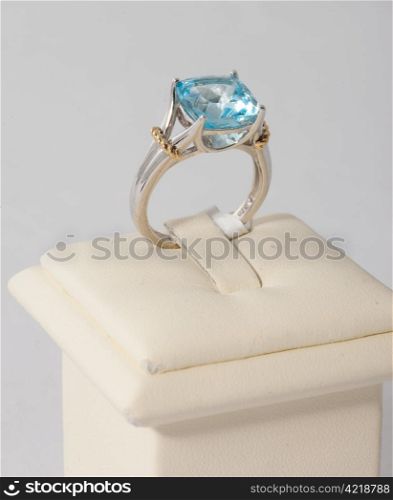Ring with blue stone on display stand
